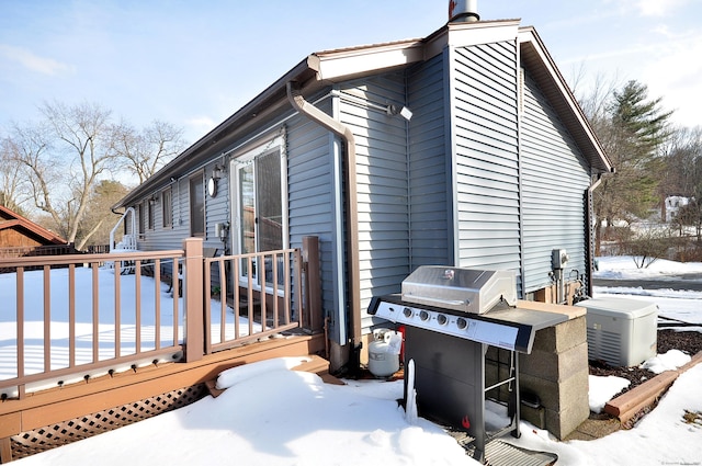 view of snow covered exterior with a wooden deck