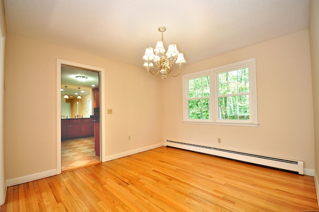unfurnished room with a chandelier, a baseboard radiator, light wood-style flooring, and baseboards