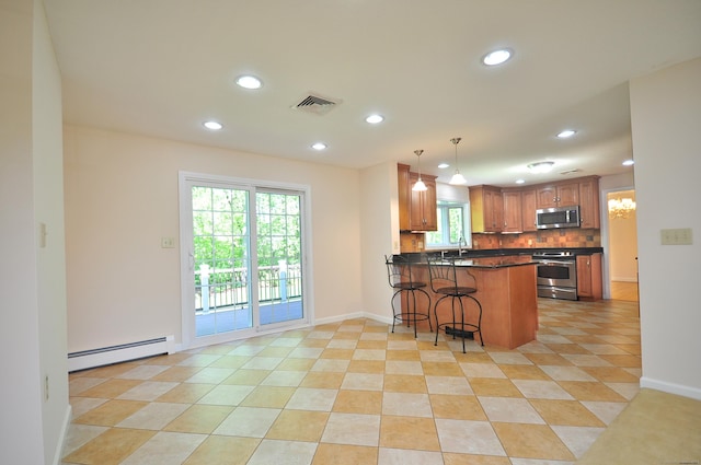 kitchen with stainless steel microwave, a baseboard heating unit, stove, recessed lighting, and tasteful backsplash