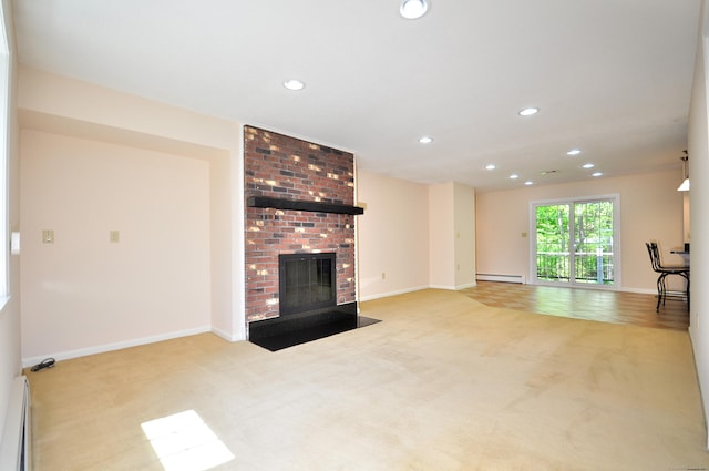 unfurnished living room with carpet floors, a baseboard heating unit, recessed lighting, a brick fireplace, and baseboards