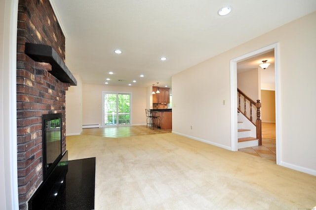 unfurnished living room with a fireplace, light colored carpet, a baseboard radiator, stairs, and baseboards