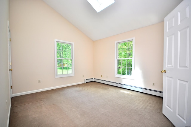 empty room with a baseboard heating unit, carpet flooring, a skylight, lofted ceiling, and baseboards