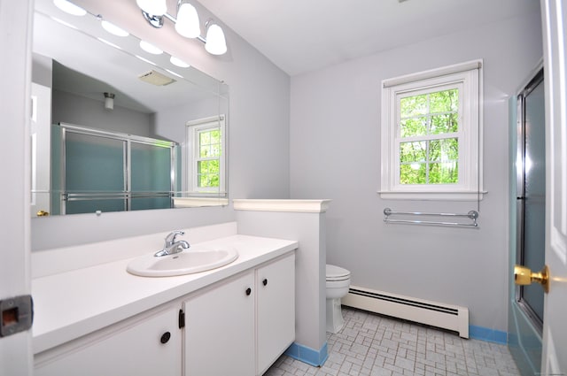 full bathroom with a baseboard heating unit, toilet, vanity, and baseboards