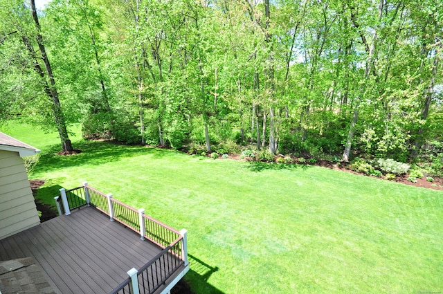 view of green lawn featuring a wooden deck