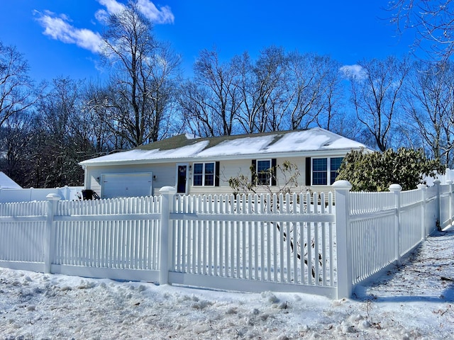 view of front of property with a fenced front yard and an attached garage