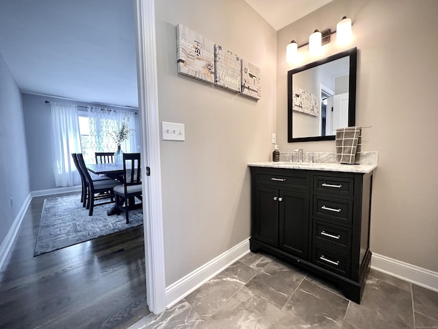 bathroom with vanity and baseboards