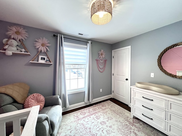 sitting room featuring baseboards, visible vents, and dark wood-type flooring