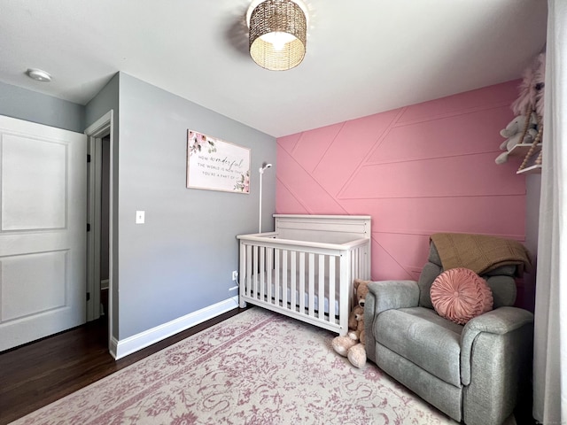 bedroom featuring wood finished floors and baseboards