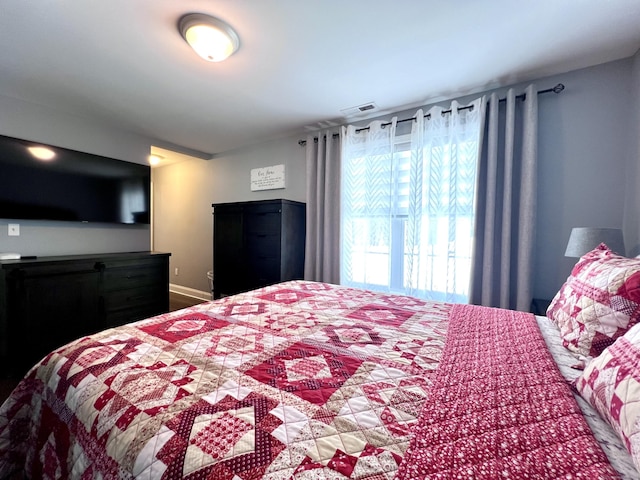 bedroom featuring visible vents and baseboards