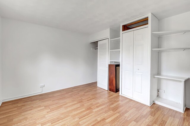 367DBUILDING5 Granfield Ave, Bridgeport, CT 06610 - unfurnished bedroom featuring light wood finished floors and multiple closets