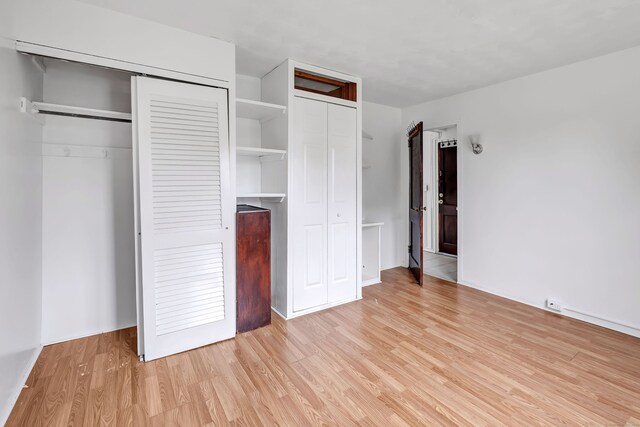 367DBUILDING5 Granfield Ave, Bridgeport, CT 06610 - unfurnished bedroom with light wood-style floors and two closets