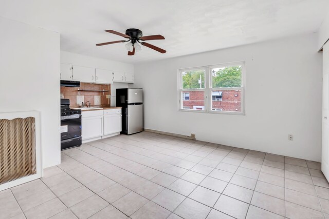 367DBUILDING5 Granfield Ave, Bridgeport, CT 06610 - kitchen with black range with gas stovetop, freestanding refrigerator, extractor fan, a sink, and ceiling fan