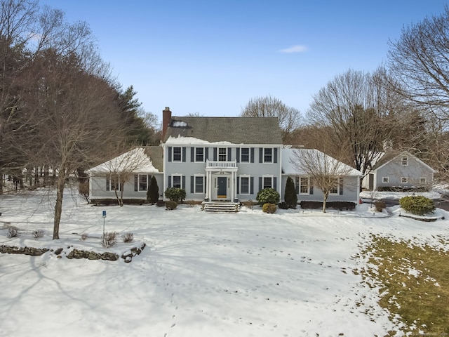 snow covered house with a chimney