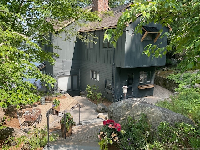 exterior space with a chimney and board and batten siding