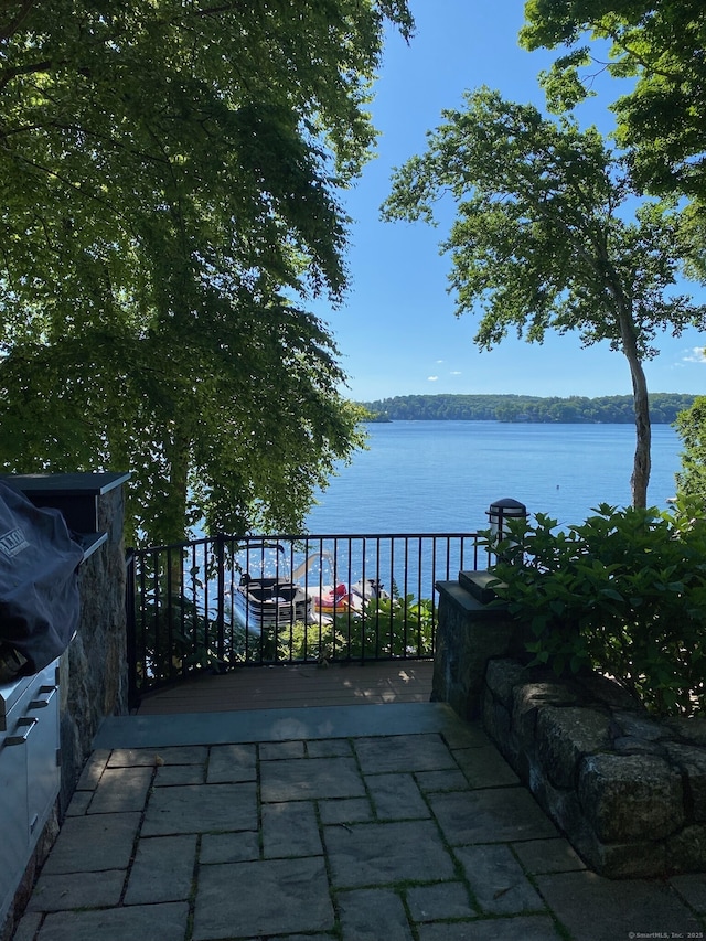 view of patio / terrace featuring a water view and a balcony