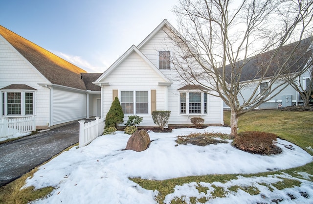 view of front of property with aphalt driveway and fence