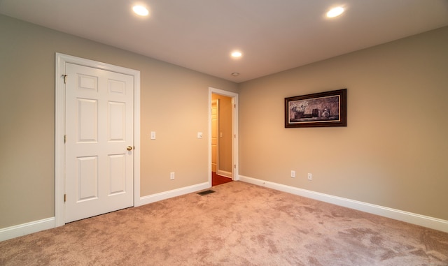 unfurnished bedroom featuring recessed lighting, carpet flooring, visible vents, and baseboards