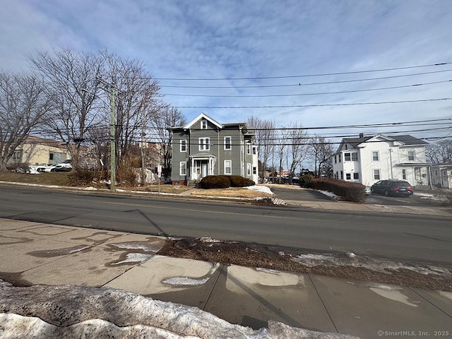 view of road with curbs, sidewalks, and a residential view