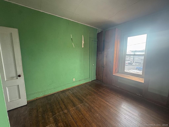 empty room with dark wood-type flooring