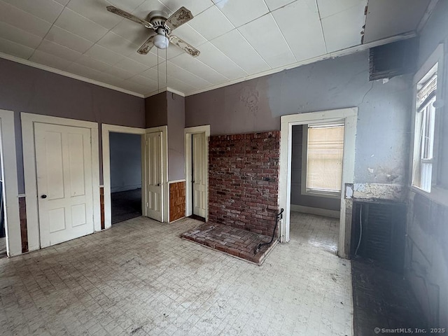 unfurnished bedroom featuring multiple windows, crown molding, and light floors