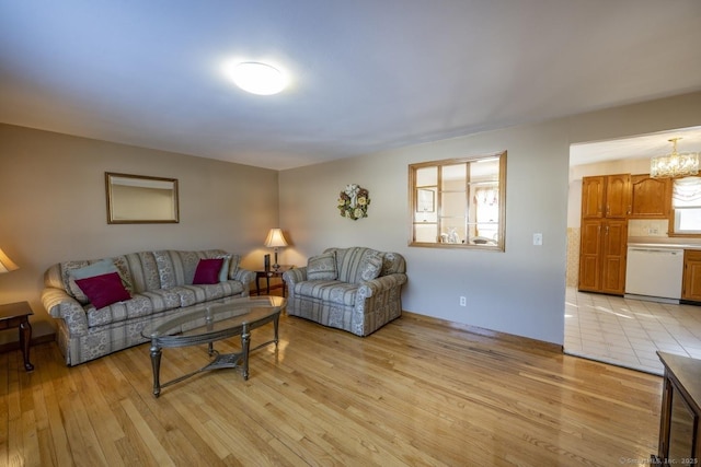 living room with a chandelier and light wood-style flooring