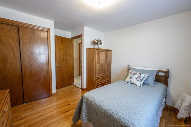 bedroom with light wood-type flooring and a closet