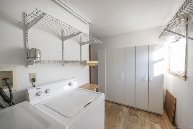 laundry area featuring laundry area, washer and clothes dryer, and light wood-style floors