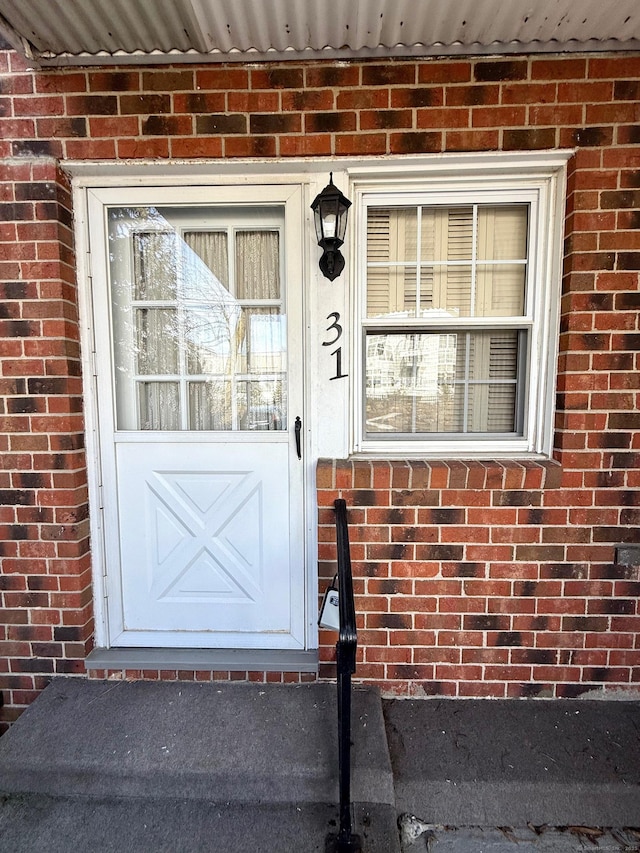 entrance to property with brick siding