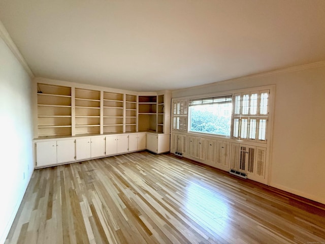 unfurnished room featuring visible vents, crown molding, and light wood-style flooring