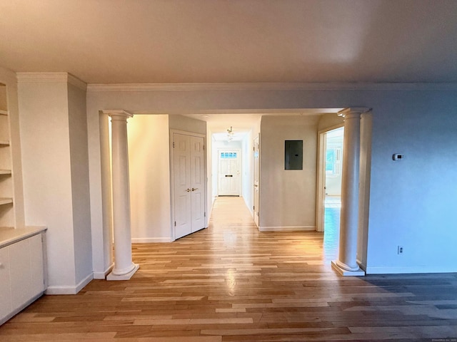 hall featuring electric panel, crown molding, ornate columns, and wood finished floors