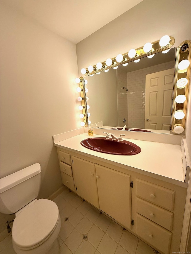 bathroom featuring tile patterned flooring, vanity, and toilet