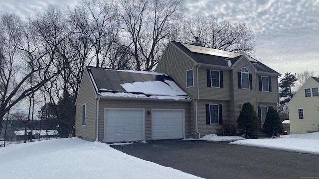 view of front of home featuring a garage and aphalt driveway