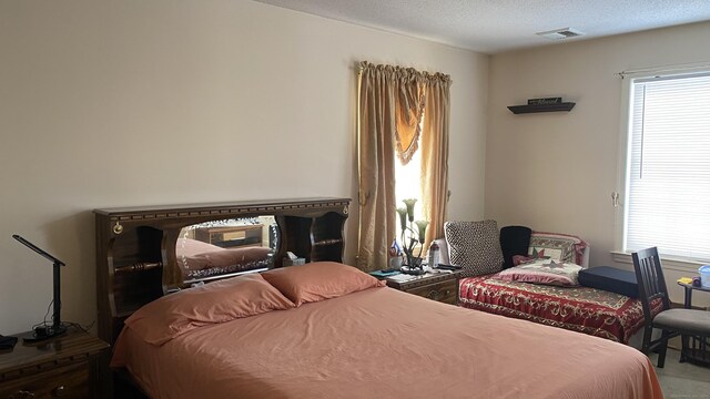 bedroom featuring visible vents and a textured ceiling