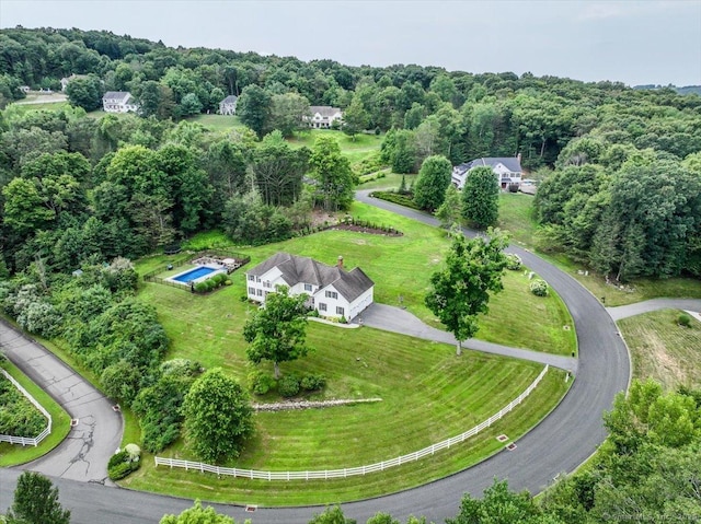 drone / aerial view featuring a forest view