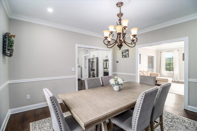 55 Country Woods Ln, Southbury, CT 06488 - dining space featuring ornamental molding, dark wood-type flooring, an inviting chandelier, and baseboards
