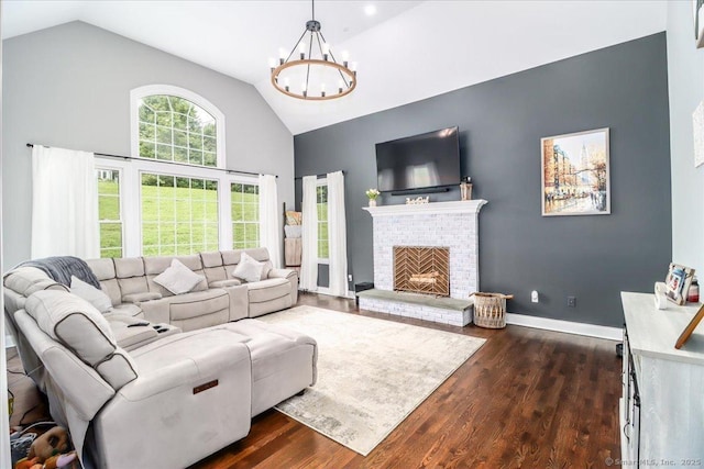 55 Country Woods Ln, Southbury, CT 06488 - living room with dark wood-style floors, a fireplace, an inviting chandelier, high vaulted ceiling, and baseboards