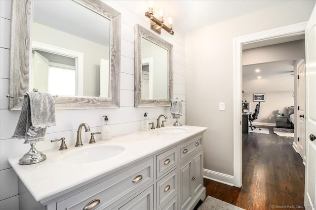 55 Country Woods Ln, Southbury, CT 06488 - full bath featuring double vanity, baseboards, a sink, and wood finished floors