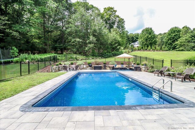 55 Country Woods Ln, Southbury, CT 06488 - view of pool with a trampoline, a fenced in pool, a yard, a patio area, and a fenced backyard
