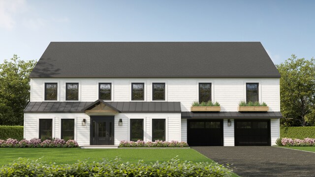 view of front facade featuring a garage, a front yard, a standing seam roof, and driveway