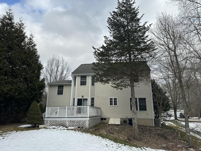 colonial house with cooling unit and a wooden deck