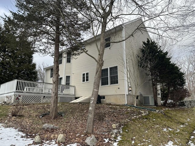 snow covered property featuring a deck