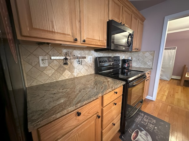75 Heather Glen Ln, Groton, CT 06355 - kitchen with black appliances, light wood-style flooring, backsplash, stone counters, and baseboards