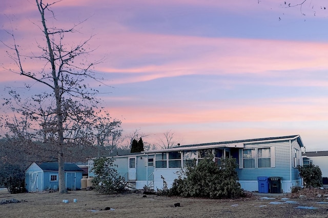 manufactured / mobile home with a shed and an outdoor structure