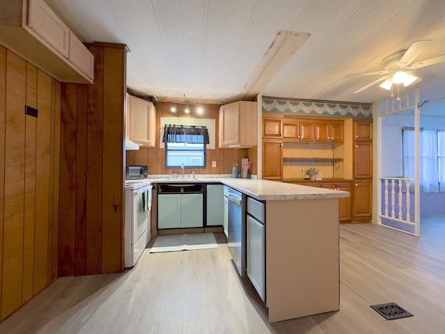 kitchen with a sink, visible vents, light countertops, light wood finished floors, and white range with electric cooktop