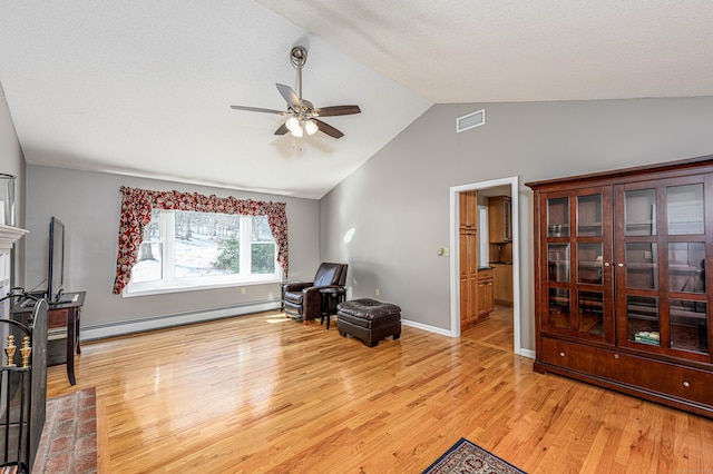 living area featuring light wood-style flooring, a baseboard heating unit, visible vents, a ceiling fan, and vaulted ceiling