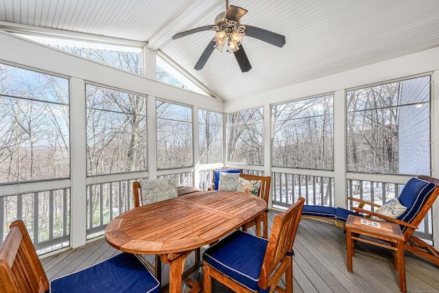 sunroom / solarium featuring vaulted ceiling with beams and a ceiling fan