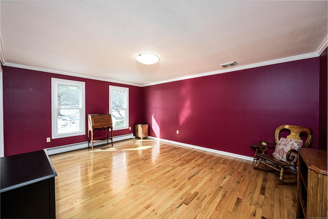 unfurnished room with crown molding, visible vents, a baseboard heating unit, light wood-type flooring, and baseboards