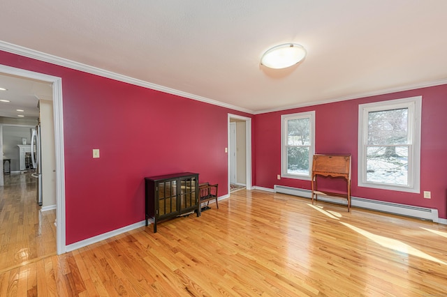 unfurnished room featuring light wood-style flooring, baseboards, baseboard heating, and crown molding