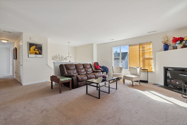 living room featuring a chandelier, visible vents, carpet flooring, and a fireplace with flush hearth