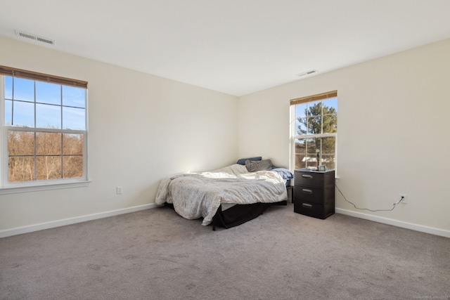 bedroom with visible vents, baseboards, and carpet floors